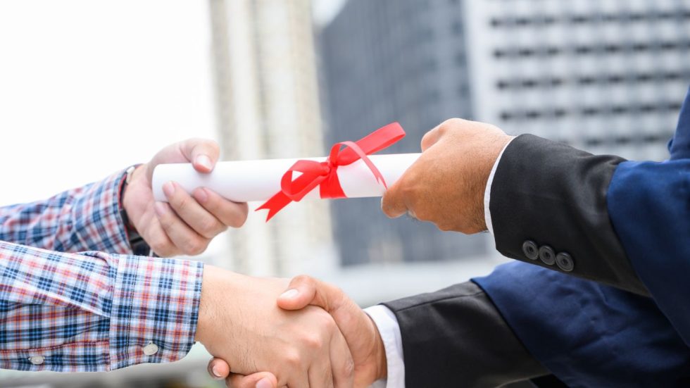 Handshake With A Graduation Certificate