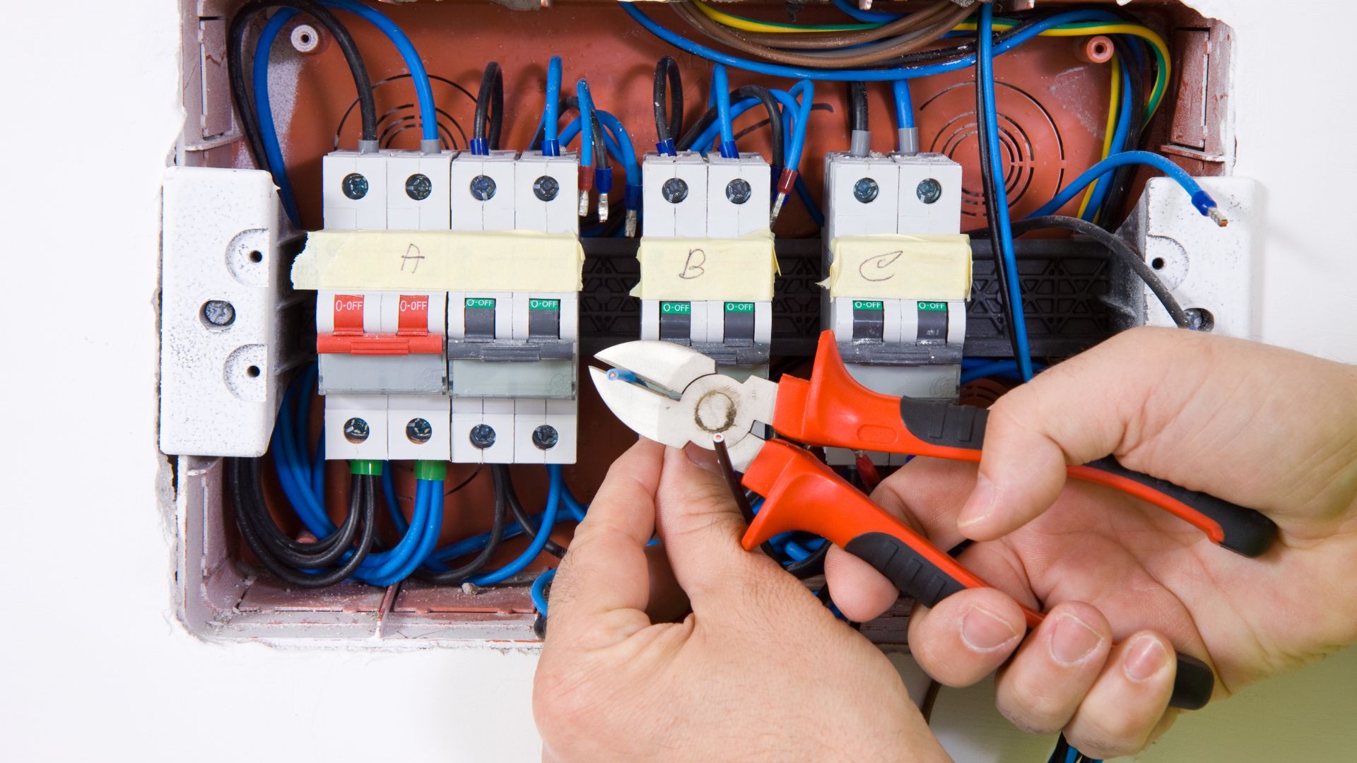 Electrician Working On A Circuit Breaker